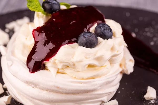 Dessert Pavlova with gentle cream, whipped cream, served with berries and jam