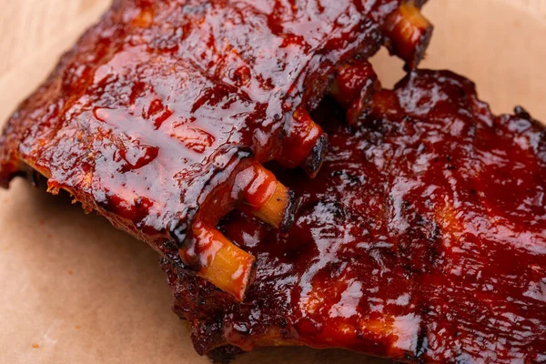 Pork baked ribs with crispy crust, served with ketchup