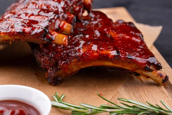 Pork baked ribs with crispy crust, served with ketchup