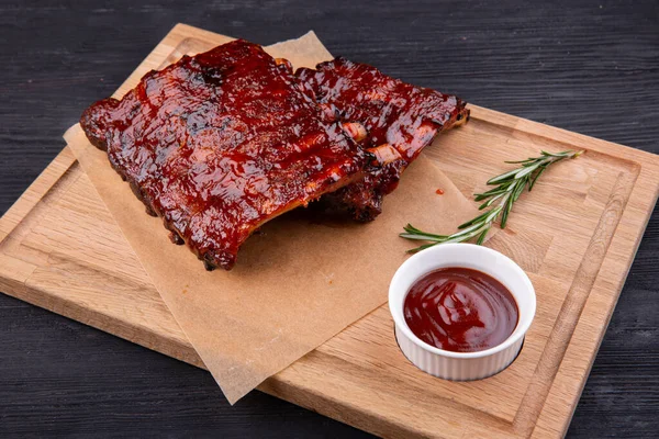 Pork baked ribs with crispy crust, served with ketchup
