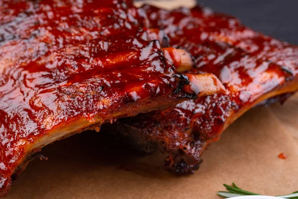 Pork baked ribs with crispy crust, served with ketchup