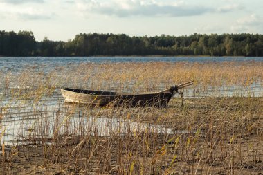 Boat moored on the mudy shore lake