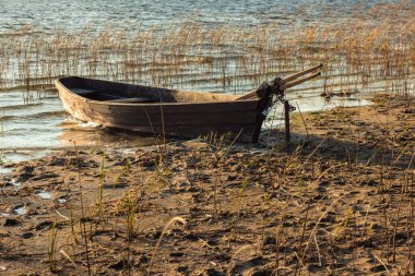 Boat moored on the mudy shore lake