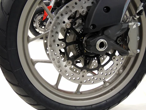 Brake disc on the front wheel of sport motorcycle at moto shop stock photo — Stock Photo, Image