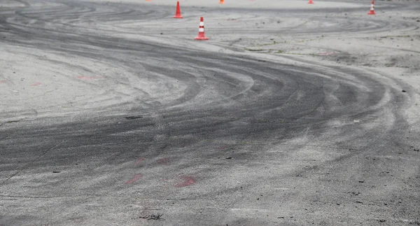Traces of tires after car burnout on the asphalt at autodrome
