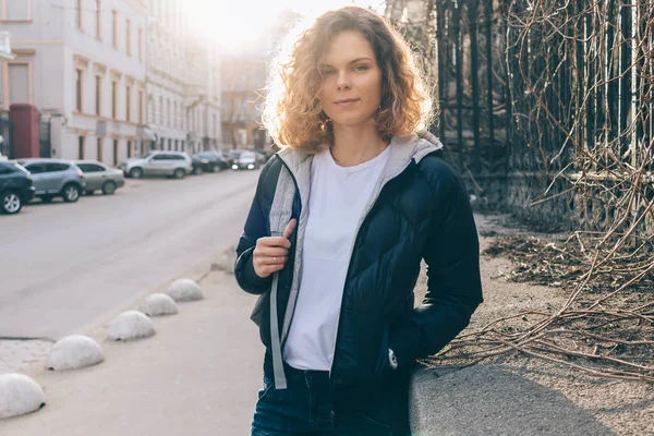 Young woman traveler looks at camera