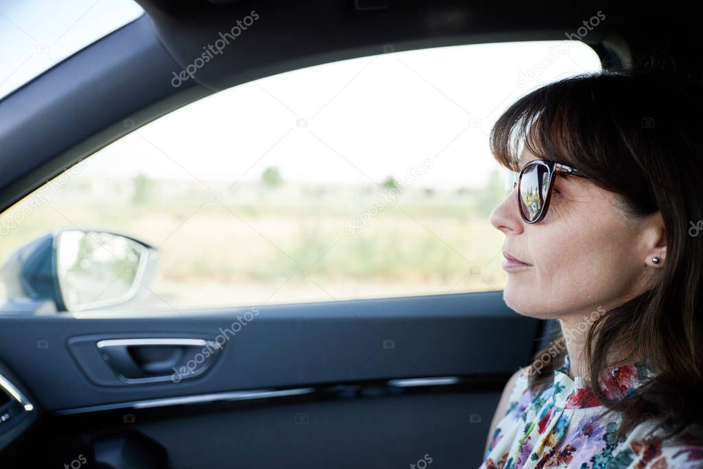 happy woman traveling in a car
