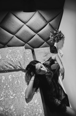 Kız bir gece lambasının ışığında çıplak yatıyor..