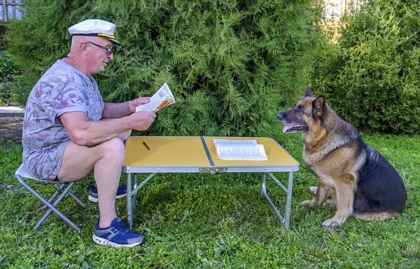 Man Dog dergisi okuyor. — Stok fotoğraf