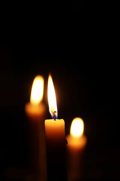 Licht Kerzenflamme isoliert auf schwarz — Stockfoto