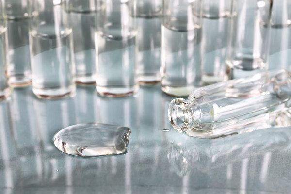 transparent vials of medicine