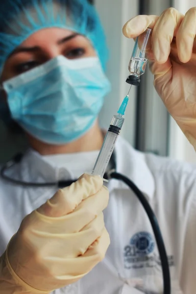 nurse hands holding syringe and ampoule
