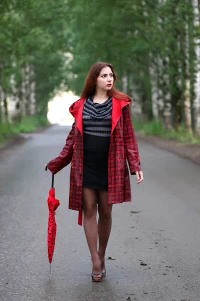 Femme en imperméable et un parapluie — Photo