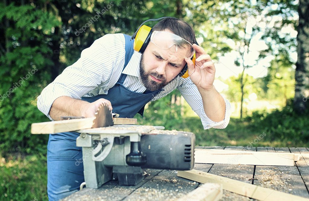 worker beard man with circular saw