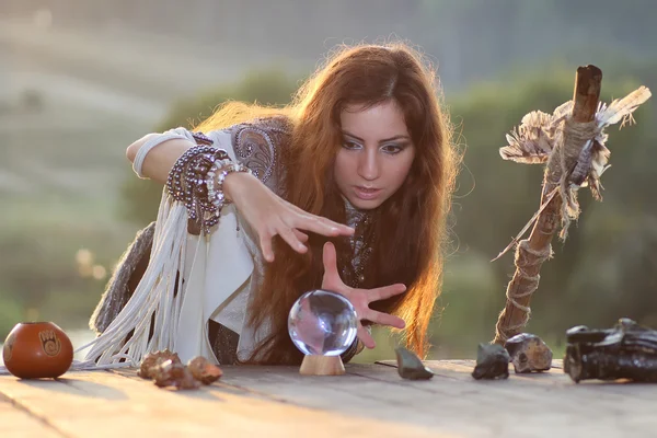 Witch with crystal ball at sunset — Stock Photo, Image