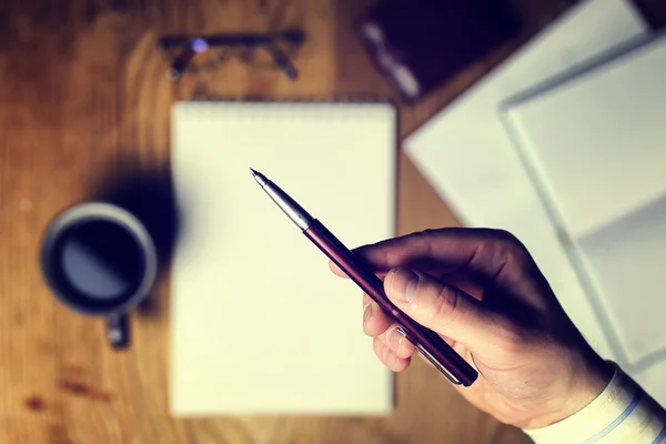 Toned table write hand top view — Stock Photo, Image