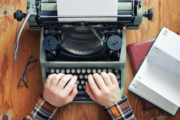 typewriter retro hand on wooden table