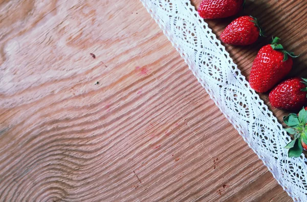 Top de fresas en madera y encaje — Foto de Stock