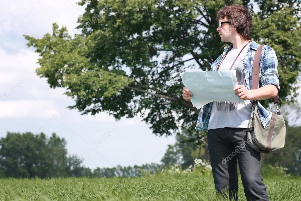 man with map in a field
