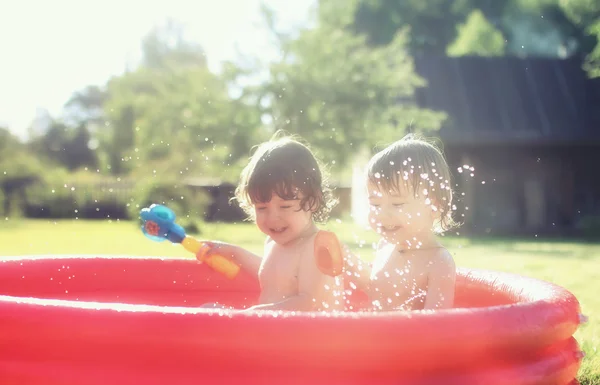 Baby splashing in the pool outdoors — Stock Photo, Image