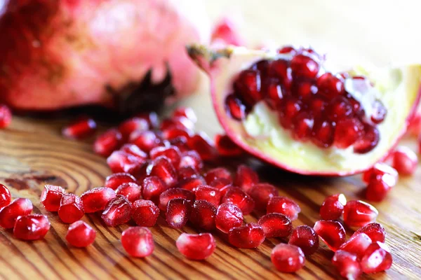 Pomegranate seed wood background — Stock Photo, Image