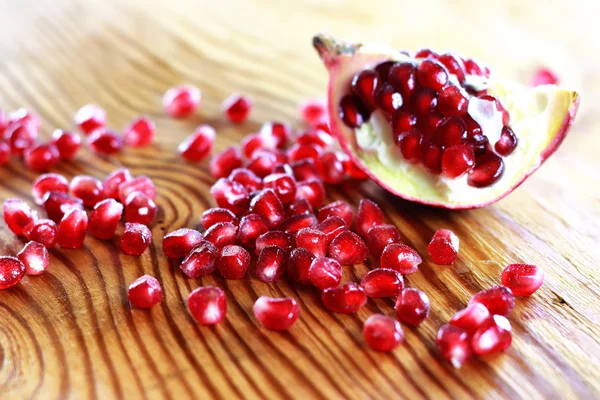 Pomegranate seed wood background — Stock Photo, Image