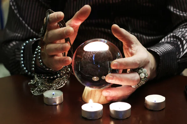 Sorcerer hands over a transparent crystal ball fortune-telling for future — Stock Photo, Image