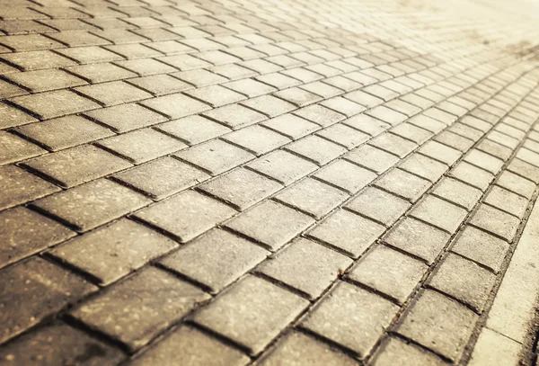 Sunlight on paved cobblestone pavement — Stock Photo, Image