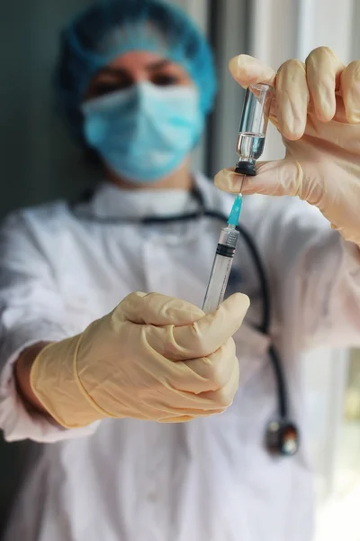 nurse hands holding syringe and ampoule