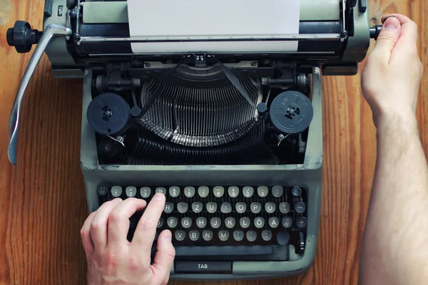 typewriter retro hand on wooden table