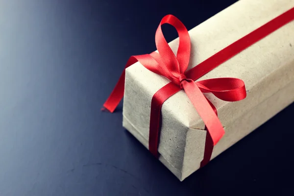 Gift red bow black background — Stock Photo, Image