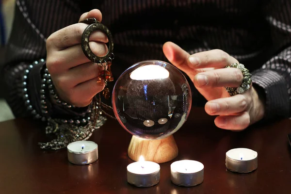 Sorcerer hands over a transparent crystal ball fortune-telling for future — Stock Photo, Image