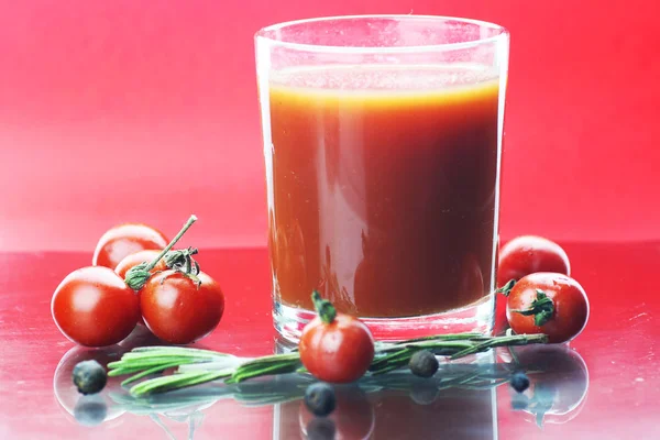 Glass of tomato juice drops — Stock Photo, Image