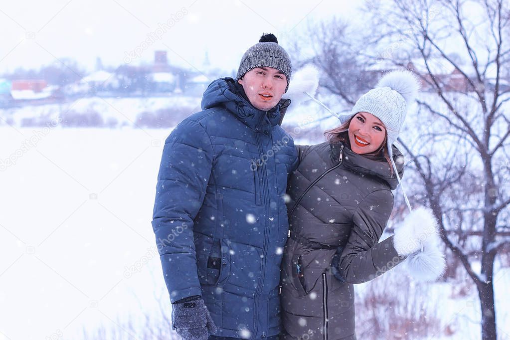young couple of lovers walk in winter park