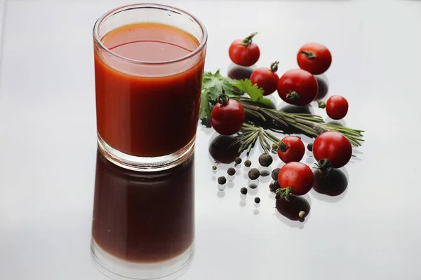 Glass of tomato juice drops — Stock Photo, Image