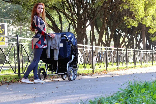 Women walk stroller summer — Stock Photo, Image