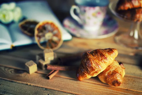 Tea cup croissant book — Stock Photo, Image
