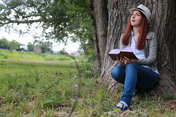 girl with book in park