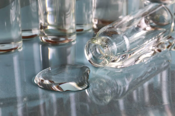 transparent vials of medicine