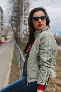 Sonbaharda parkta kulaklıklı bir kadın.