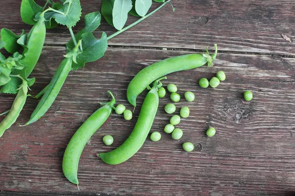 Erbsenschale auf dem hölzernen Hintergrund — Stockfoto