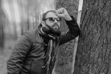 Kulaklıklı, parktaki sakallı adam.