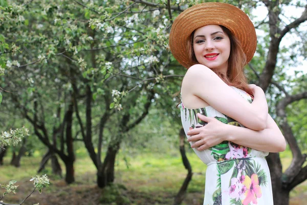 Chica en vestido y sombrero de paja en el parque — Foto de Stock