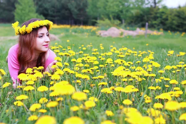 Young woman on dandelion meadow — Stock Photo, Image
