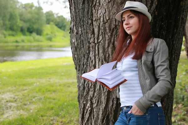 girl with book in park