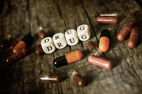 Old shabby filthy Photo drug pill on wooden table concept addict — Stock Photo, Image