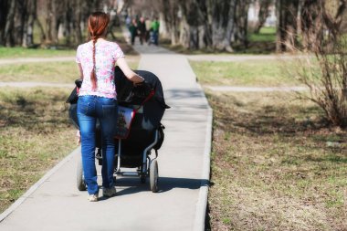 genç anne ile bebek arabası park