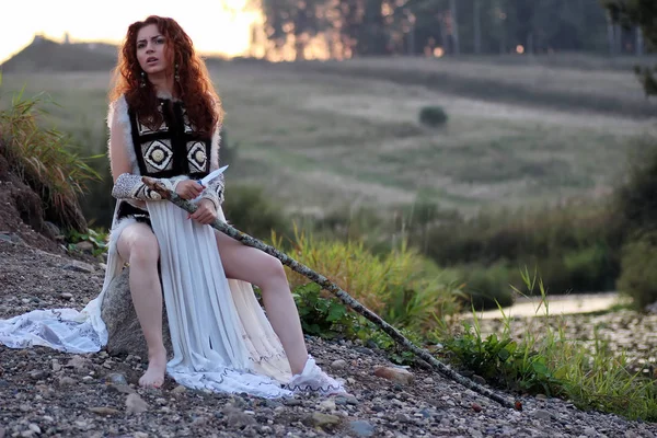 Girl with spear at the river — Stock Photo, Image