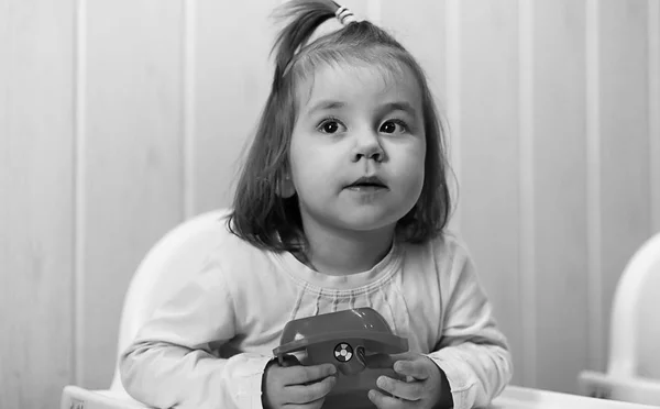 Чорно-біла фотографія дитини, яка посміхається і веселиться білим фоном — стокове фото