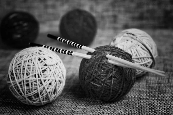 embroidery wool balls and knitting needles